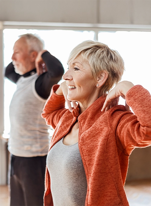 Active Middle Aged Couple Stretching Together