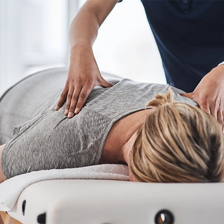 Patient Laying Face Down Receiving Chiropractic Adjustment