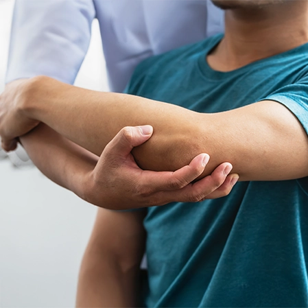 Patient Receiving Elbow Mobilization Physical Therapy