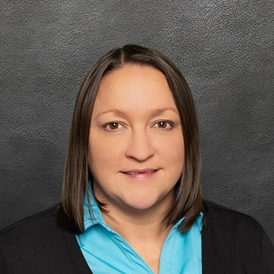 Chiropractor Amanda Pennekamp Smiling In Light Blue Shirt