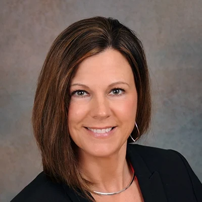Chiropractor Amy Zimmerman Smiling In Blazer And Necklace