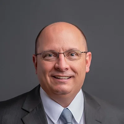 Chiropractor Sun Prairie WI Jeffrey Horkan About Chiropractor Jeffrey Horkan Smiling In Grey Suit With Patterned Tie