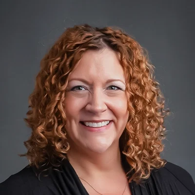 Chiropractor Sara Kirkman Smiling In Black Top And Necklace