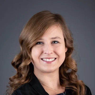 Chiropractor Emily Wilcox Smiling In Black Top And Necklace