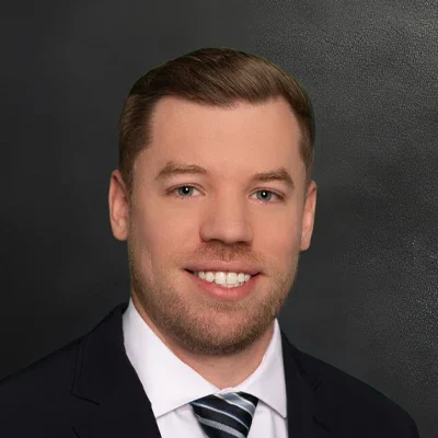 Chiropractor Ryan Weyenberg Smiling In Black Suit With white Shirt