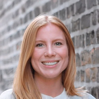 Functional Medicine Madison WI Ashley Woyak About Naturopathic Doctor Ashley Woyak Smiling In Front Of Brick Wall