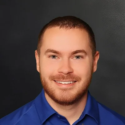 Functional Medicine Middleton WI Nathan Mohr About Physical Therapist Nathan Mohr Smiling In Blue Shirt